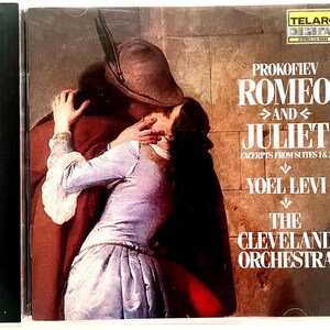 May include: A CD cover featuring a painting of a couple embracing. The title "Prokofiev Romeo and Juliet" is printed in large, bold letters. The text "Excerpts from Suites 1 & 2" is printed below the title. The composer's name, "Yoel Levi", and the orchestra's name, "The Cleveland Orchestra", are printed below the text.