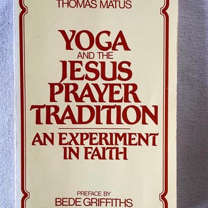 May include: A softcover book with a cream-colored cover and a red border. The title reads Yoga and the Jesus Prayer Tradition: An Experiment in Faith by Thomas Matus, with a preface by Bede Griffiths, all printed in red serif lettering.