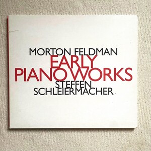 May include: A square album cover with a white background and red and black text. The text reads "MORTON FELDMAN EARLY PIANO WORKS STEFFEN SCHLEIERMACHER."