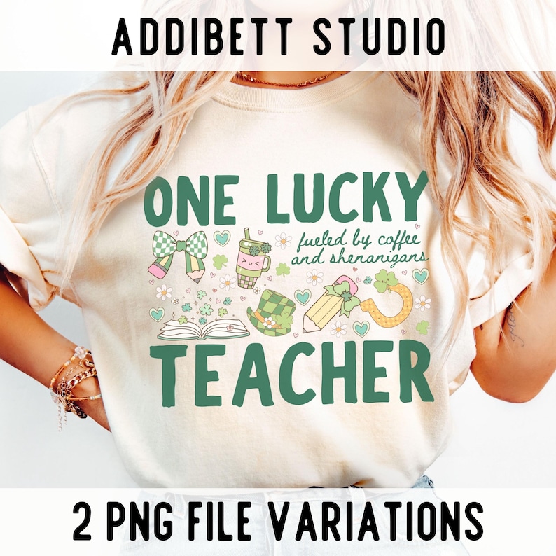 May include: Cream-colored t-shirt with the text "ONE LUCKY TEACHER" in green, along with St. Patrick's Day-themed graphics. The shirt also includes the phrase "fueled by coffee and shenanigans". The top text says "ADDIBETT STUDIO".
