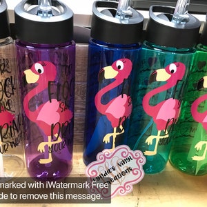 May include: Four clear plastic water bottles with pink flamingo designs and the text "For Flock Sake Drink Your Water".