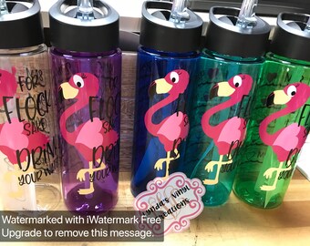 May include: Four clear plastic water bottles with pink flamingo designs and the text "For Flock Sake Drink Your Water".