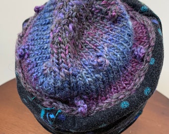 Soft cozy black and blue winter hat from repurposed and hand - knitted yarns with a silk neck tie brim.