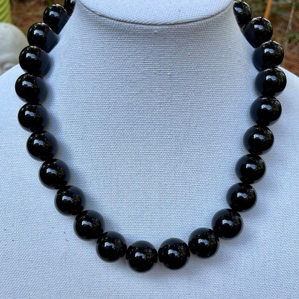 Black Big Beads Strung on Super Strong Elastic. Can be put on over the head. 20mm beads.