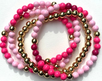 Pink Bunch of Stretchy Bracelets. Round Enamel Beads. Gold beads. Set of 4.