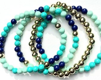 Blue Bunch of Stretchy Bracelets. Round Enamel Beads. Gold beads. Set of 4.