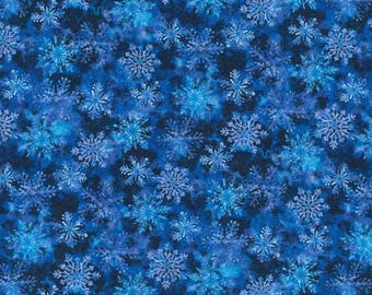 May include: A seamless pattern of blue snowflakes on a dark blue background. The snowflakes are of varying sizes and are arranged in a random pattern.
