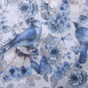 以下が含まれることがあります： 水彩画風の生地で、青い花柄に青い鳥が2羽とトンボが描かれています。