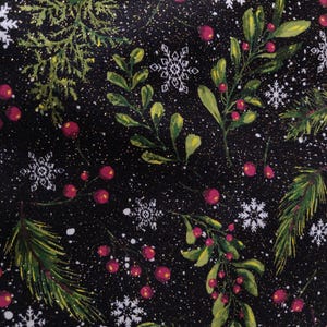 May include: A black fabric featuring a festive pattern of green pine branches, mistletoe sprigs with red berries, and white snowflakes. The design is accented with scattered gold glitter particles throughout the dark background.