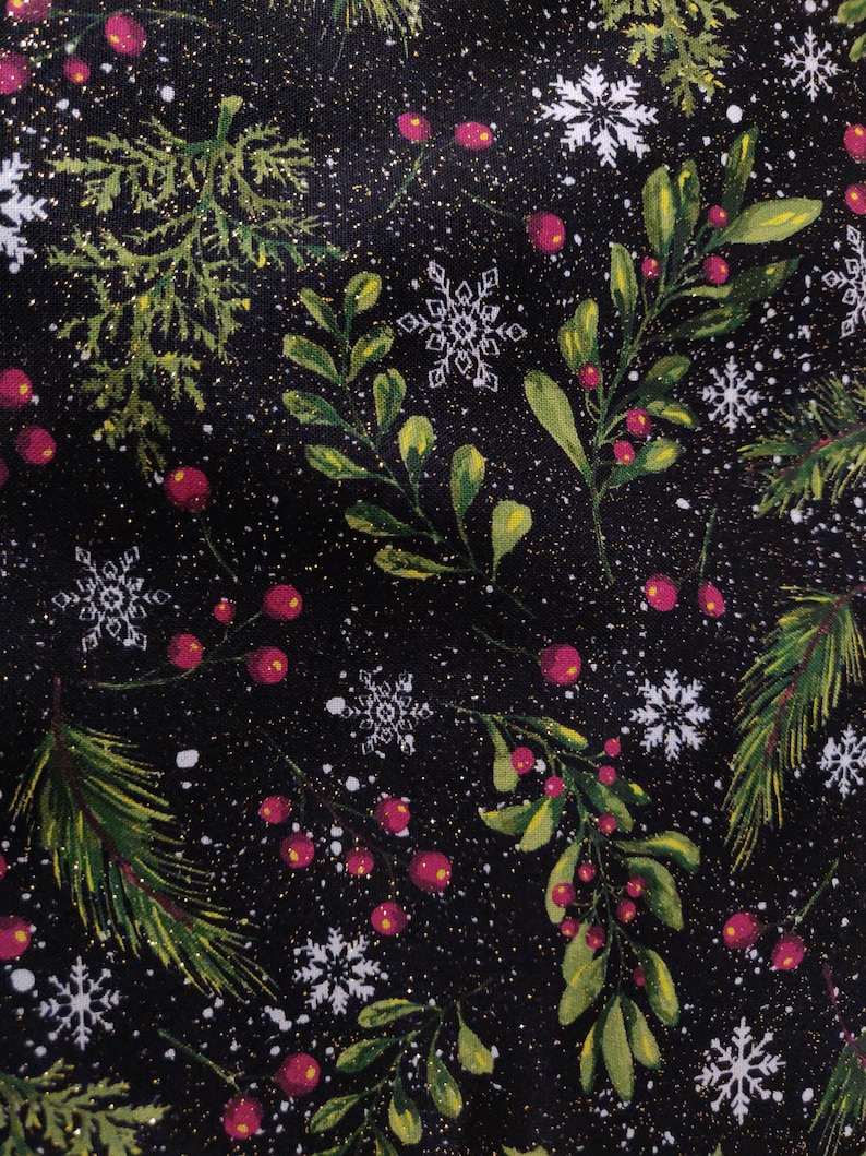 May include: A black fabric featuring a festive pattern of green pine branches, mistletoe sprigs with red berries, and white snowflakes. The design is accented with scattered gold glitter particles throughout the dark background.