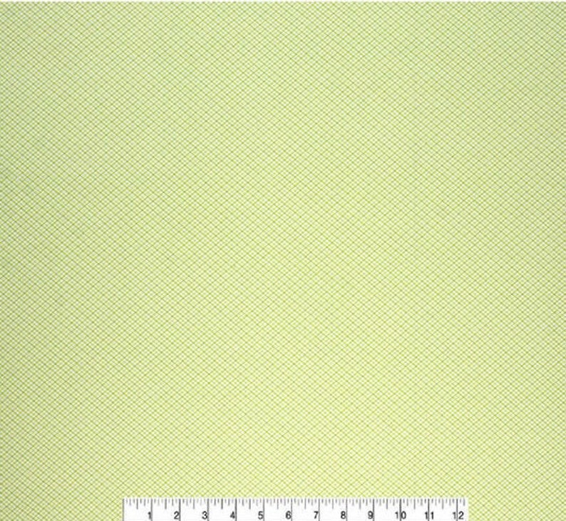 May include: A light green fabric with a subtle diamond pattern. The fabric has a smooth texture and a slightly shiny finish.
