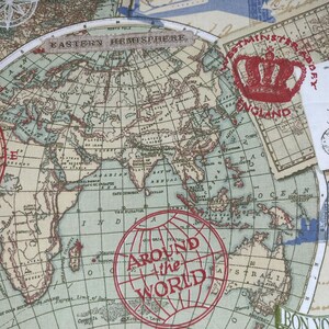 May include: A fabric with a vintage world map design, featuring a compass rose, the Eiffel Tower, and stamps that say "England" and "Around the World." The map is in shades of blue, beige, and red.