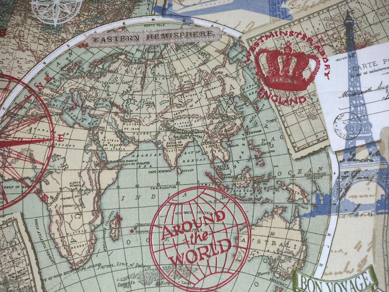 May include: A fabric with a vintage world map design, featuring a compass rose, the Eiffel Tower, and stamps that say "England" and "Around the World." The map is in shades of blue, beige, and red.