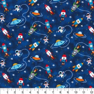 May include: A blue fabric with a repeating pattern of spaceships, astronauts, and stars. The spaceships are red, white, and blue. The astronauts are wearing white spacesuits. The stars are white.