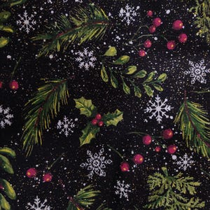 May include: A black fabric featuring a festive holiday pattern of green pine branches, holly leaves, clusters of red berries, and white snowflakes. The design includes a subtle gold glitter effect scattered across the dark background.