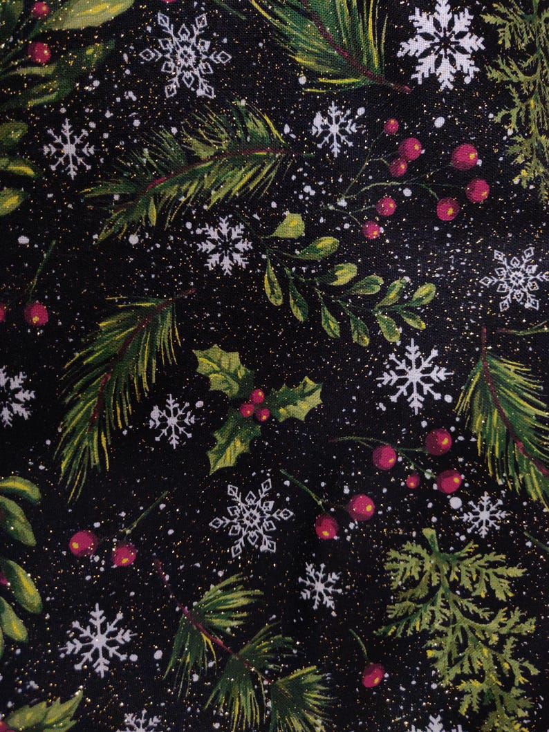 May include: A black fabric featuring a festive holiday pattern of green pine branches, holly leaves, clusters of red berries, and white snowflakes. The design includes a subtle gold glitter effect scattered across the dark background.