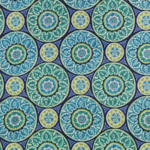 May include: A seamless fabric pattern featuring a repeating design of blue, green, and white circles with intricate floral patterns. The background is a deep blue.