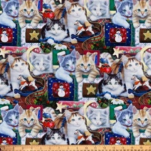 May include: A colourful fabric featuring a repeating pattern of kittens in various poses, surrounded by Christmas-themed decorations such as ornaments, presents, and a rocking horse. The fabric is a blend of red, green, blue, and white.