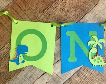 Banner de trona con número de dinosaurio