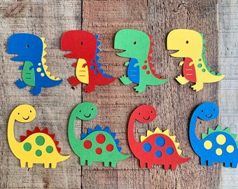 May include: Eight flat paper dinosaur cutouts arranged in two rows. The top row features four bipedal dinosaurs in blue, red, green, and yellow. The bottom row features four long-necked sauropod dinosaurs in yellow, green, red, and blue.
