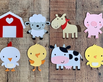 May include: A collection of eight paper die-cut farm animal and building shapes, including a red barn with a white heart, a gray sheep, a tan horse with a red bandana, a pink pig, a white chicken, two yellow chicks, and a black and white cow.