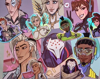 May include: A collection of colorful, holographic stickers featuring characters from the video game Overwatch. The stickers feature characters like Mercy, Genji, Tracer, and D.Va. The stickers are perfect for adding a touch of personality to laptops, water bottles, or other surfaces.