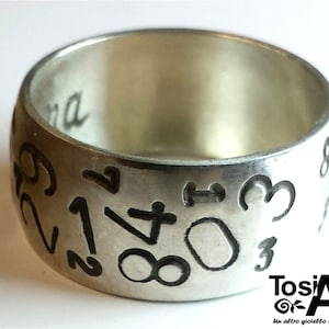Personalized text ring, with random numbers engraved.