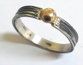 Sterling silver ring blackened, with paralel lines and 18 K gold drop, and personalized text.