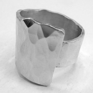 Open aluminum ring handmade forged with facet texture and personalized text.