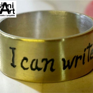 Ring with custom text in silver and brass.