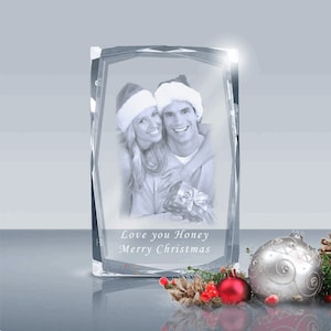 May include: A crystal photo cube with a black and white photo of a couple wearing Santa hats. The text "Love you Honey Merry Christmas" is engraved on the cube.