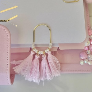 Accessoire d&#39;agenda pour la Saint-Valentin avec un trombone pour carnet de voyage et un signet avec un pompon rose