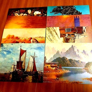 May include: A set of eight vintage postcards featuring various landscapes and scenes. The postcards are printed on thick cardstock and have a glossy finish. The images include a floral arrangement, a tree, a building, a mountain range, and a sailboat.