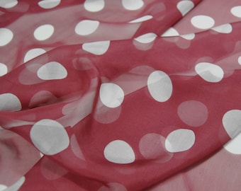 May include: Red sheer fabric with white polka dots. The fabric is translucent and the dots are slightly raised.