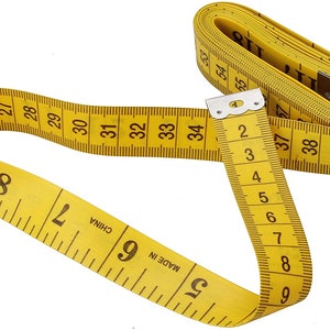 May include: A yellow measuring tape with black markings. The tape is coiled and shows numbers from 25 to 40 inches. The tape is labeled "MADE IN CHINA".