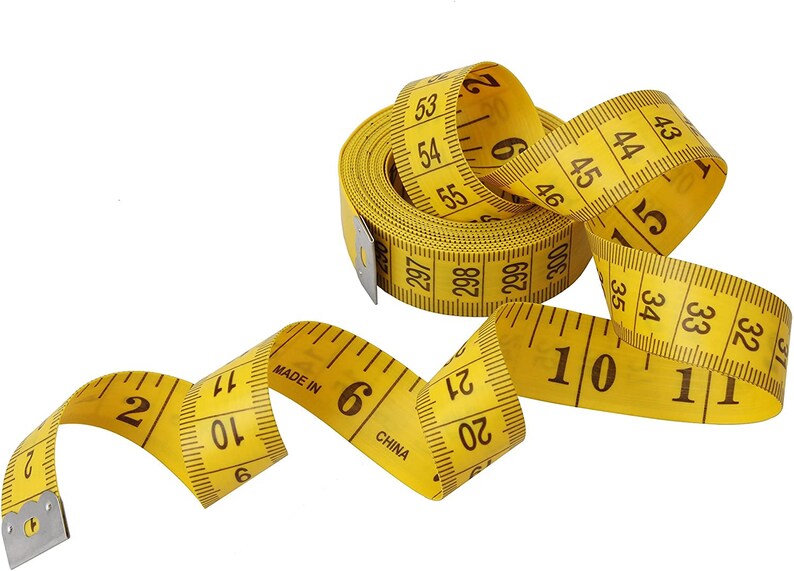 May include: A yellow measuring tape with black markings is coiled and uncoiled. The tape reads "Made in China" and has numbers from 2 to 55.