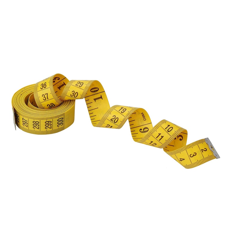 May include: A yellow measuring tape with black numbers is coiled up. The tape is marked in inches and has the word "CHINA" printed on it.