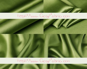 May include: Close-up of olive green silk fabric with soft folds and a subtle sheen. The fabric has text in the upper left corner that says "Silk" and "29#苔藓绿". The text "http://www.Crosyfabric.com" is also visible.