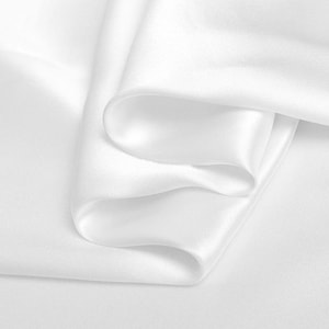 May include: White satin fabric folded in soft, flowing waves. The fabric is smooth and luxurious, with a subtle sheen.