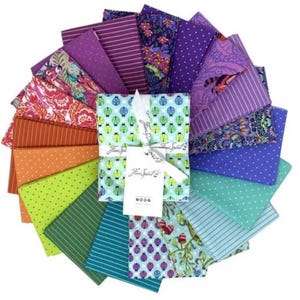 May include: A collection of colorful fabric squares arranged in a circular pattern. The fabrics feature various patterns, including stripes, polka dots, and floral designs, in shades of purple, orange, green, and blue. A bundle of fabric squares is tied with a white ribbon and a tag.