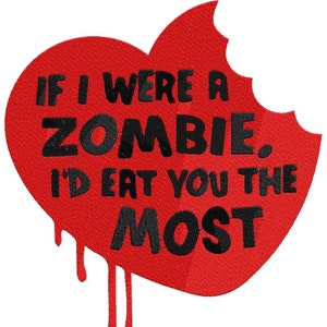 May include: A red heart-shaped design with the text "IF I WERE A ZOMBIE, I'D EAT YOU THE MOST" in black. The heart has a bite taken out of it and dripping blood-like accents. The design is by KaZoodles Design.