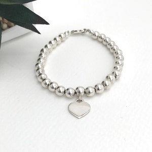 Sterling silver ball bracelet made with good quality 6mm balls, strung on strong silver chain with a sterling silver heart pendant.
