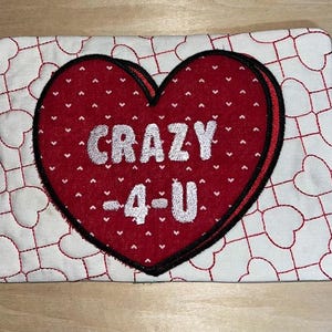 May include: A red heart-shaped pillow with white polka dots and the text "CRAZY -4- U" in white letters.
