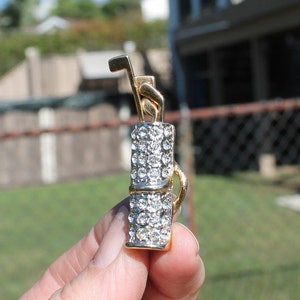 Rhinestone Gold Bag with Gold Tone Metal Trim and Golf Clubs