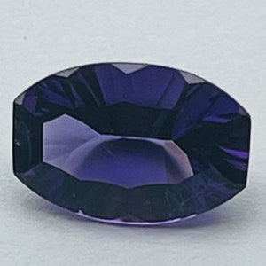 May include: A deep purple gemstone with a faceted oval shape.
