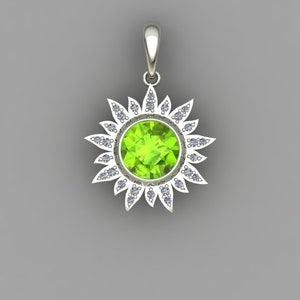 May include: A silver pendant featuring a green gemstone surrounded by a halo of smaller white gemstones. The pendant is shaped like a sun with rays extending from the center.