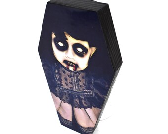 Horror doll art print on a 6" wood coffin lid frame