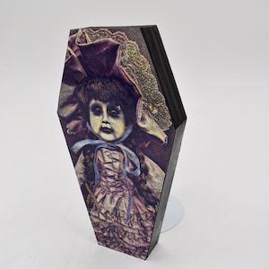 Horror doll art print on a 6&quot; wood coffin lid frame