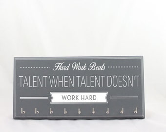 May include: Gray wooden key holder with the text "Hard Work Beats Talent When Talent Doesn't Work Hard" and eight silver hooks.