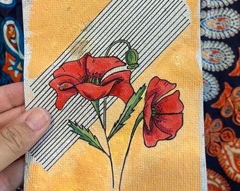 Red poppy on handmade paper